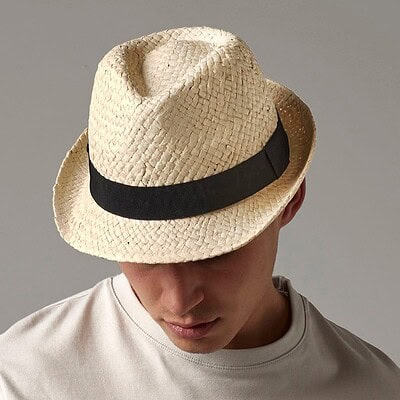 Stylish beige straw trilby hat with black band, ideal for festivals and outdoor events.