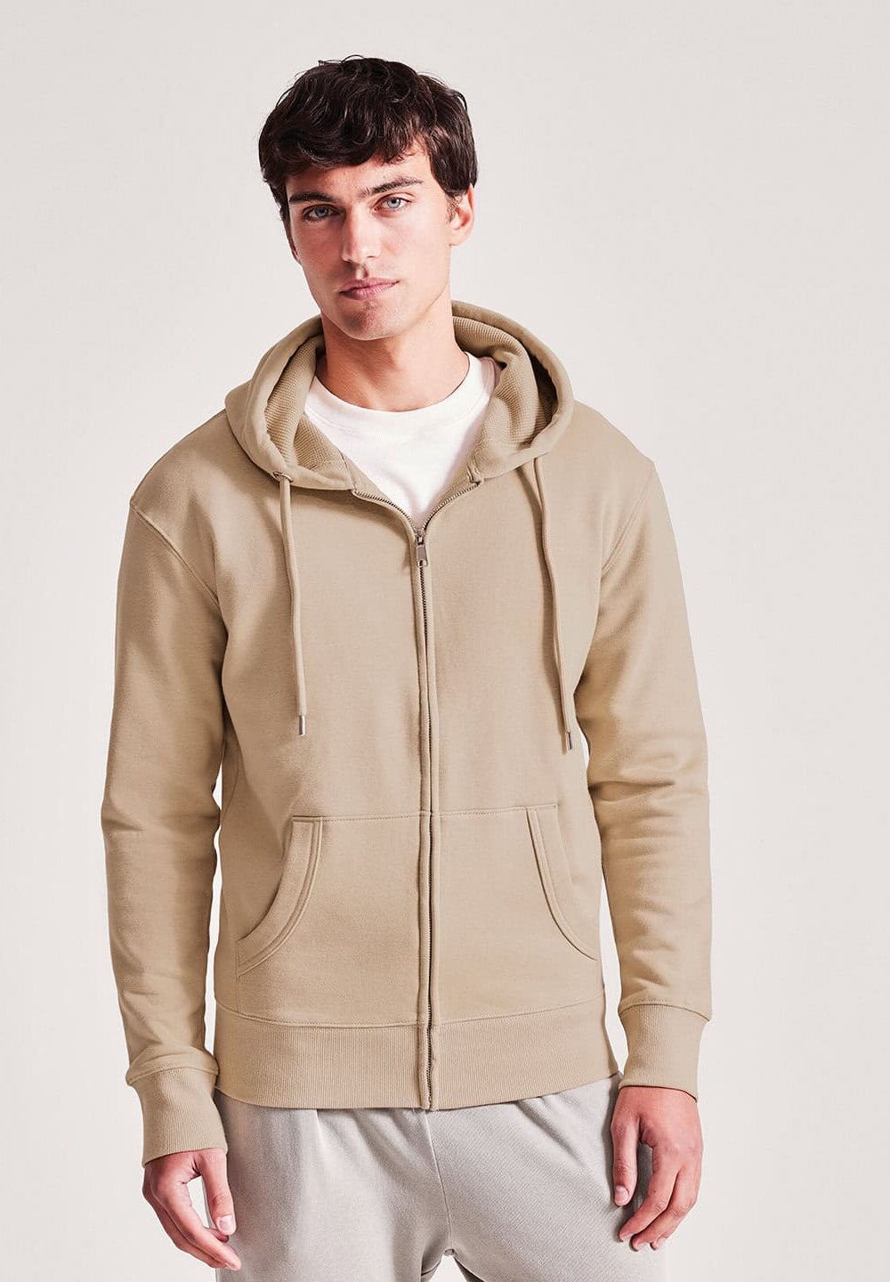 Casual beige zip-up hoodie with drawstrings and kangaroo pockets, perfect for personalised workwear and uniforms. Designed for comfort and style in embroidery and printing.