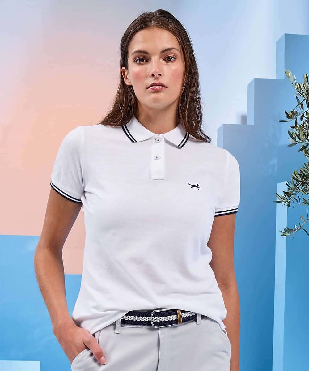 White women's polo shirt with navy trim, suitable for teamwear and work uniforms.