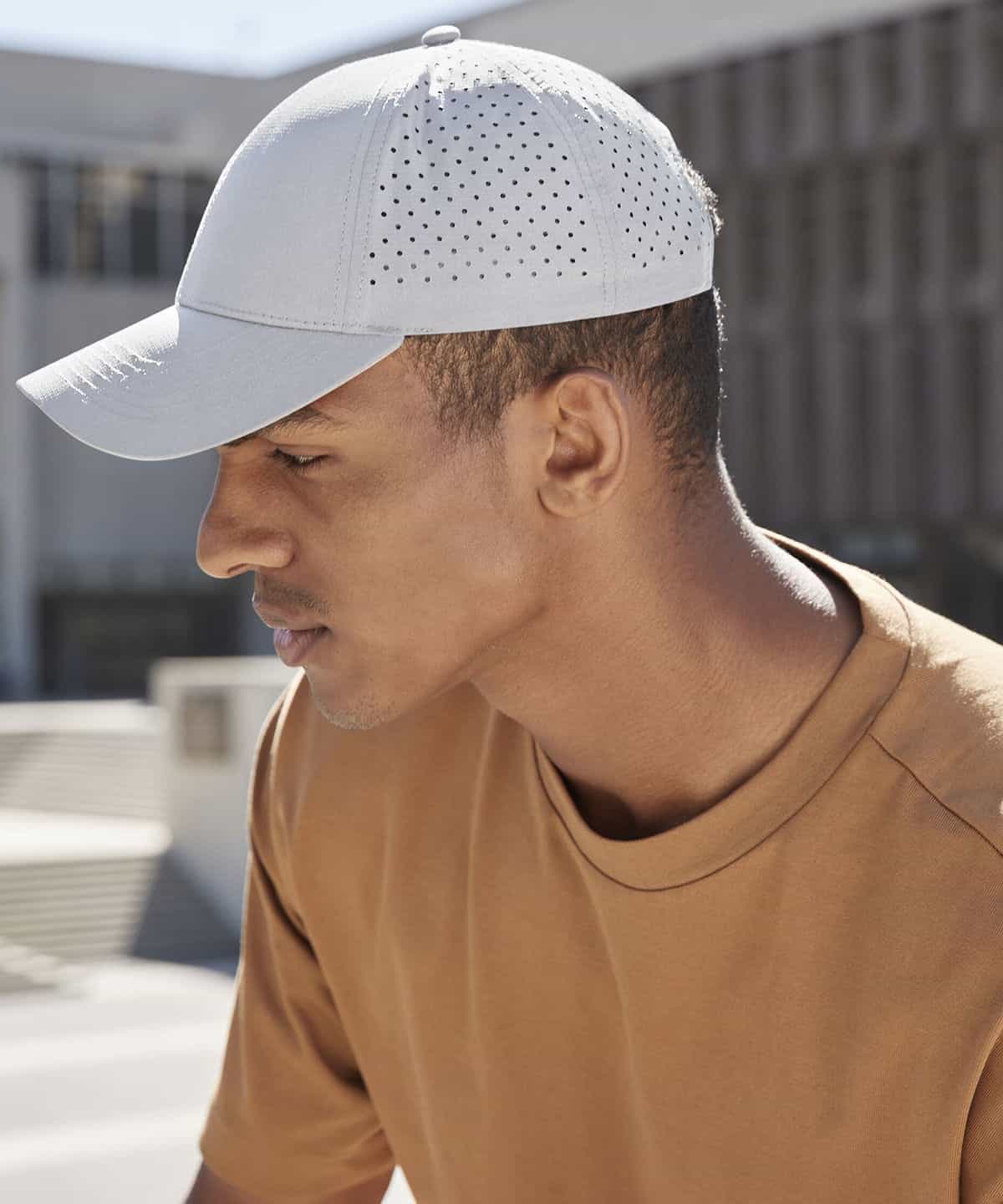 Plain white embroidered baseball cap with perforated panels for breathability, perfect for workwear or casual uniforms. Customisable with company logos or personal embroidery.