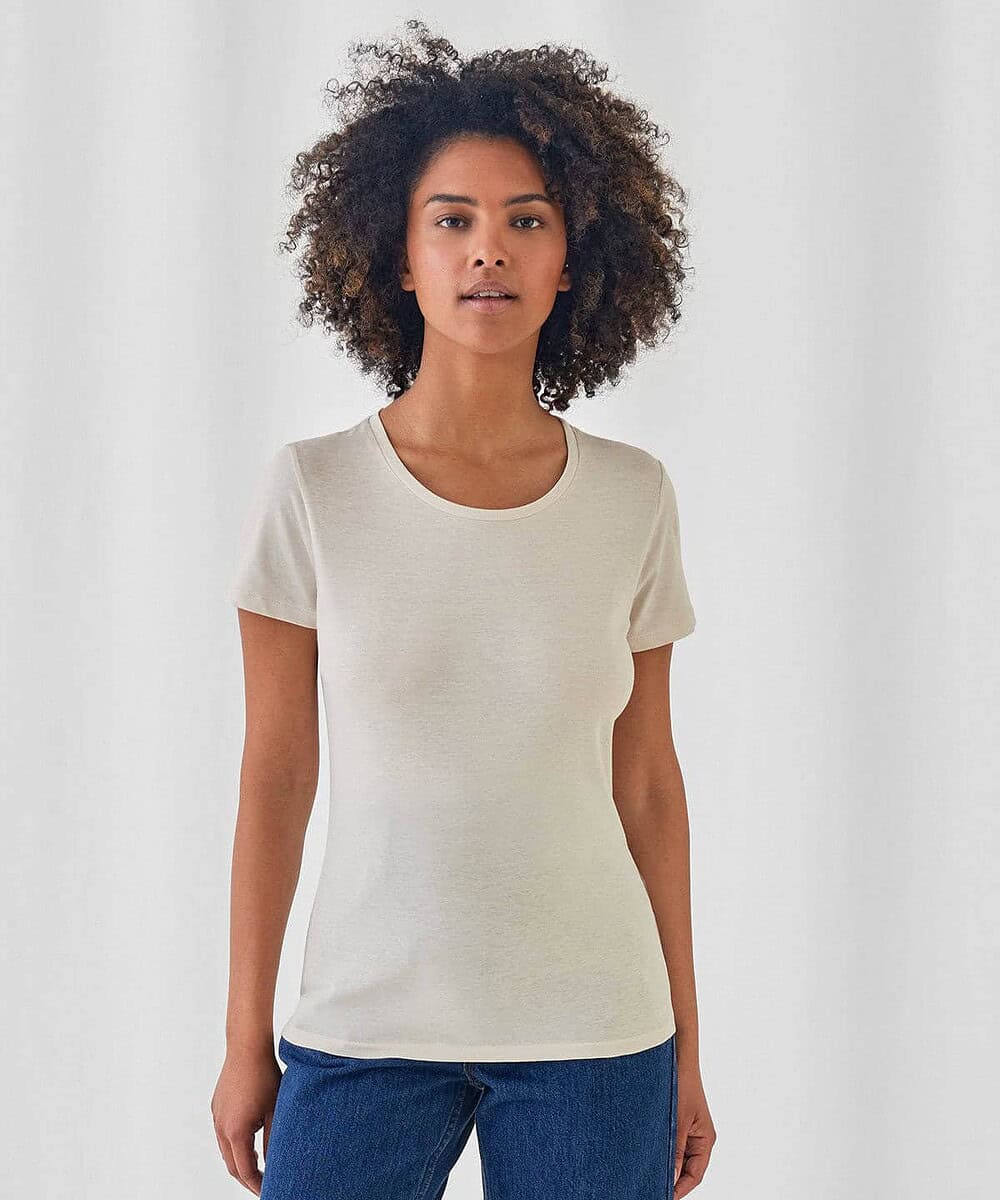 Woman wearing a plain white T-shirt, suitable for embroidery or printing.