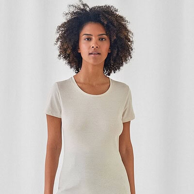 Woman wearing a plain white T-shirt, suitable for embroidery or printing.