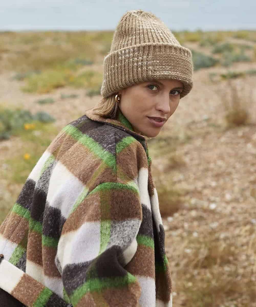 Warm beige chunky knit beanie with reverse patch design.