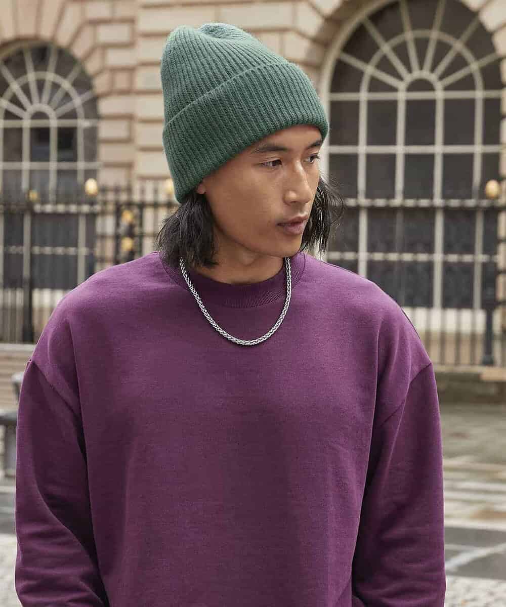 Oversized green cuffed beanie for custom embroidery and branding. Perfect for promotional headwear a.