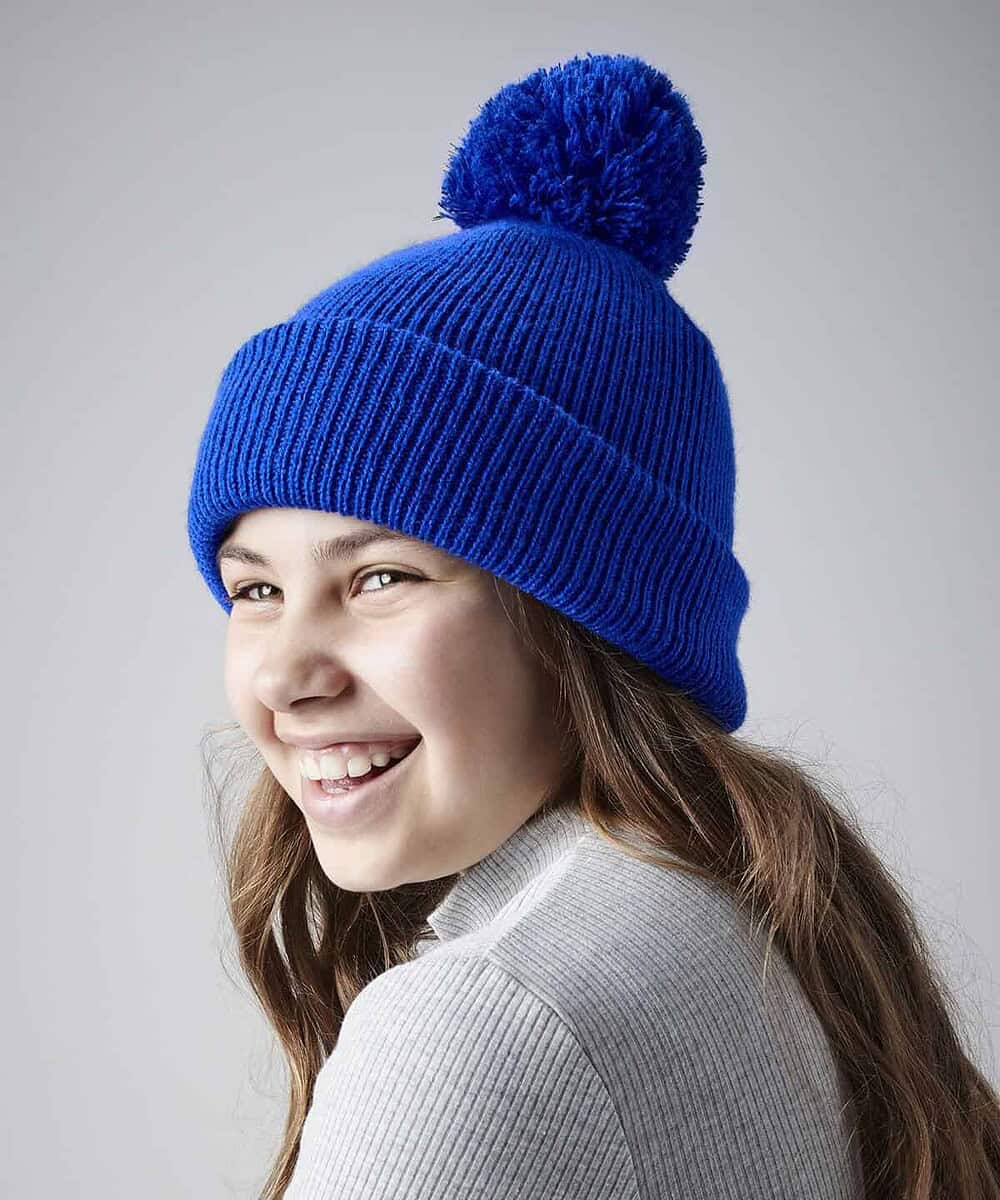 Reflective blue junior beanie with pom-pom, ideal for custom embroidery and promotional headwear.