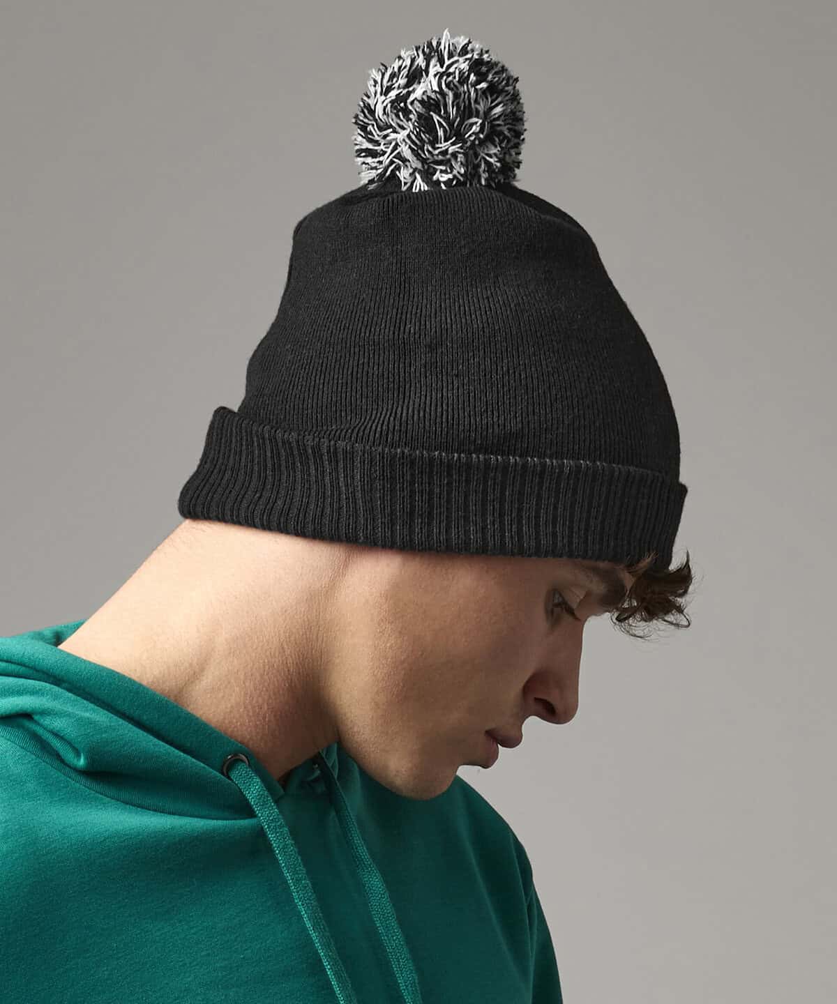 Warm black knit beanie hat with pom-pom for embroidered workwear and personalised uniforms, ideal for cold work environments or casual corporate attire.