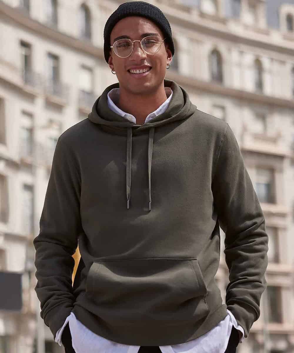 Man wearing a green hoodie with a front pocket, suitable for custom embroidery.