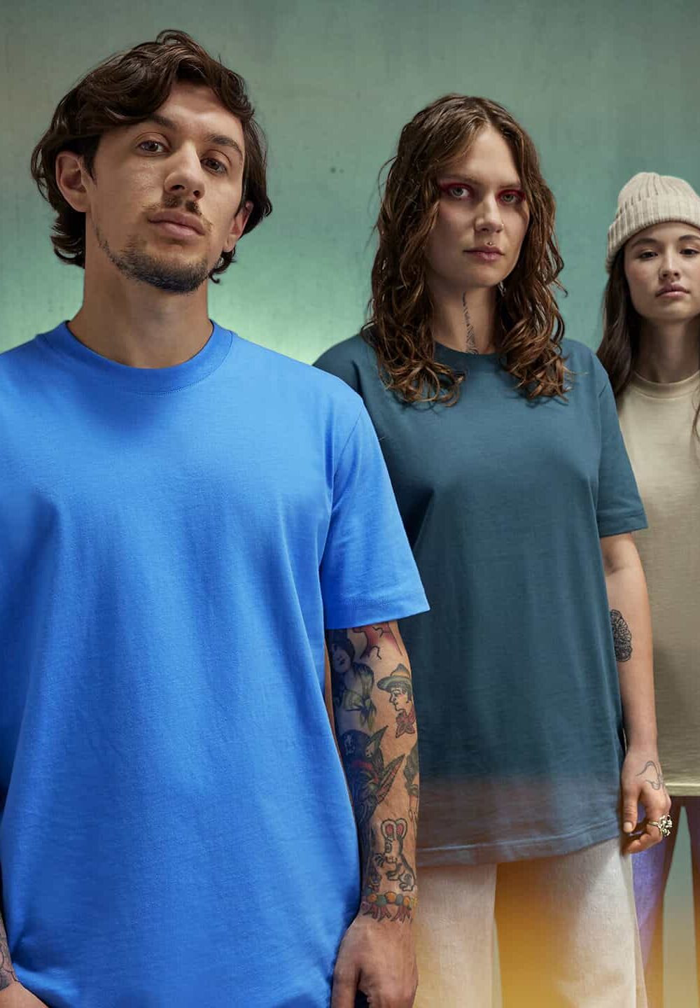 Vibrant unisex embroidered workwear T-shirts for personalised uniforms, featuring diverse styles with tattoos and fashion accessories, ideal for corporate or team branding.