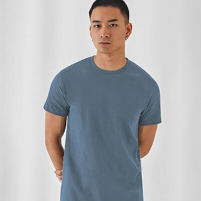 Man wearing a plain blue T-shirt, ideal for custom embroidery and printing.