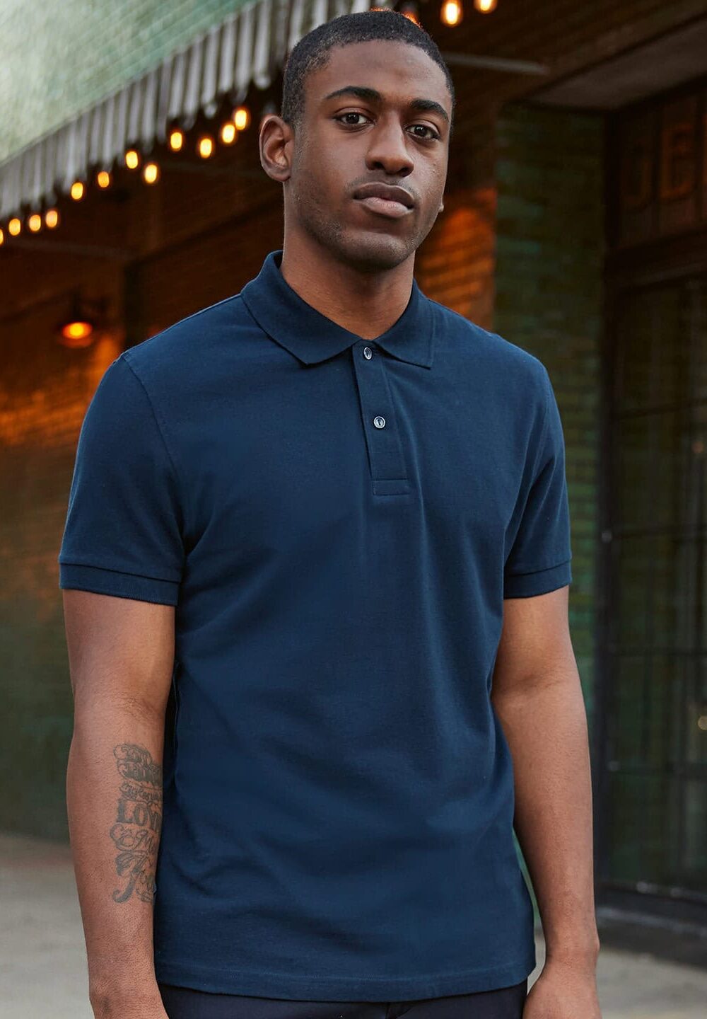 Blue polo shirt with embroidered logo, suitable for workwear and uniform branding.
