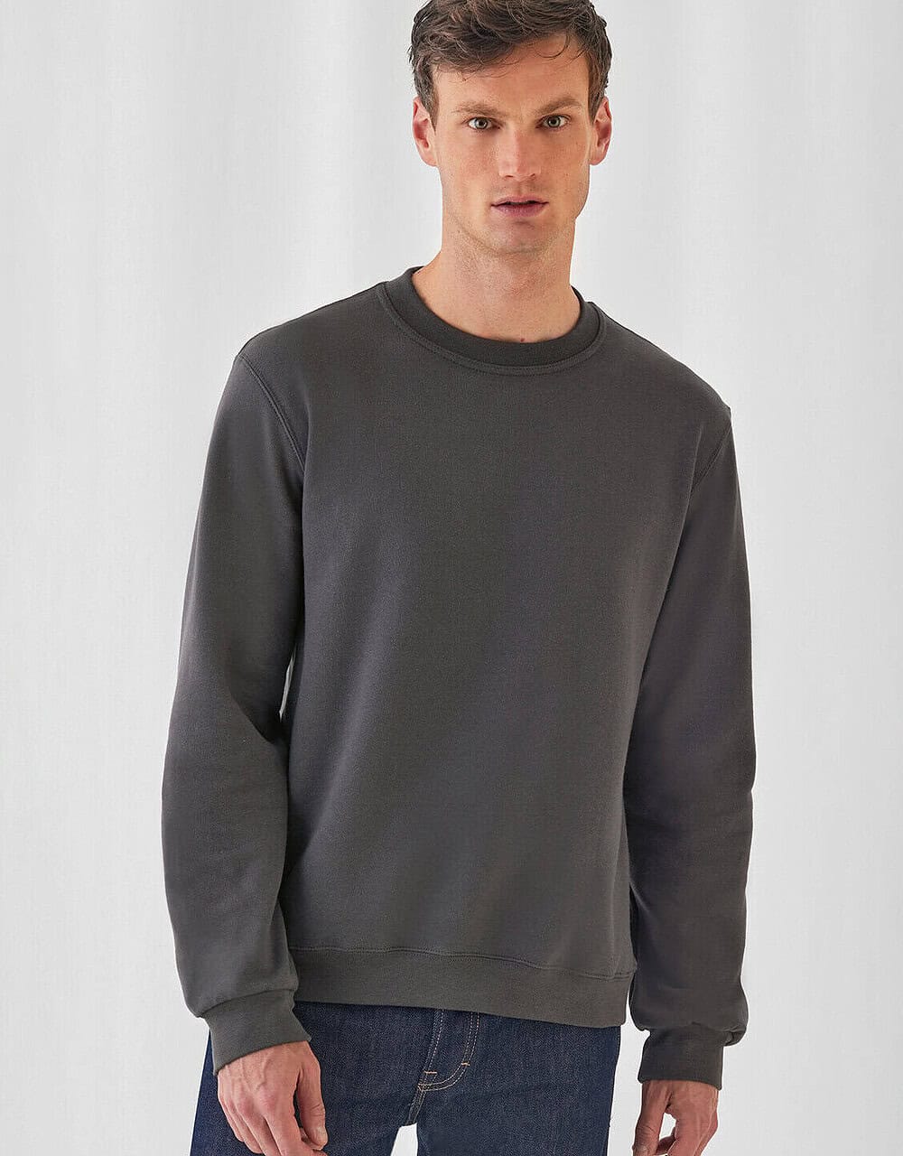 Plain dark grey crew neck sweatshirt, ideal for custom embroidery or personalised workwear for professional uniforms. Durable, comfortable, suitable for embroidery and branding.