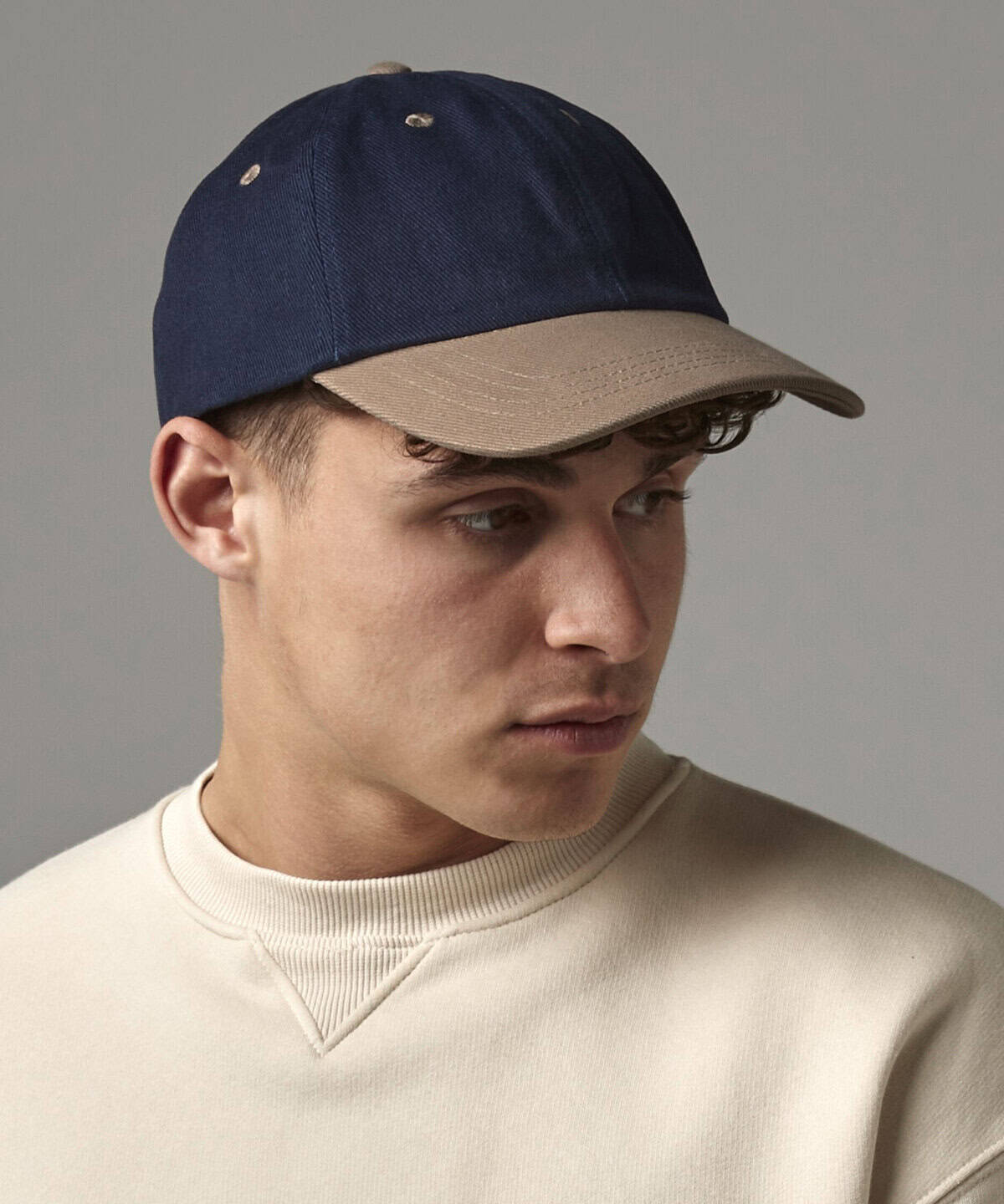 Navy and beige embroidered workwear cap, personalised with company logo, ideal for corporate uniforms and workwear, custom embroidered headwear for employees and staff.