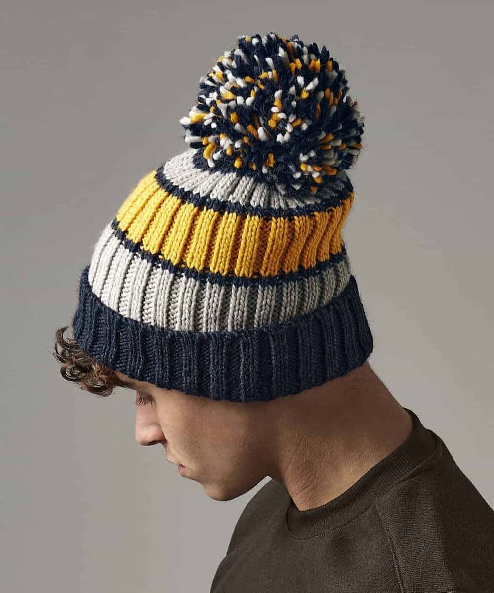 Hygge striped beanie with pom-pom, perfect for custom embroidery and promotional headwear.