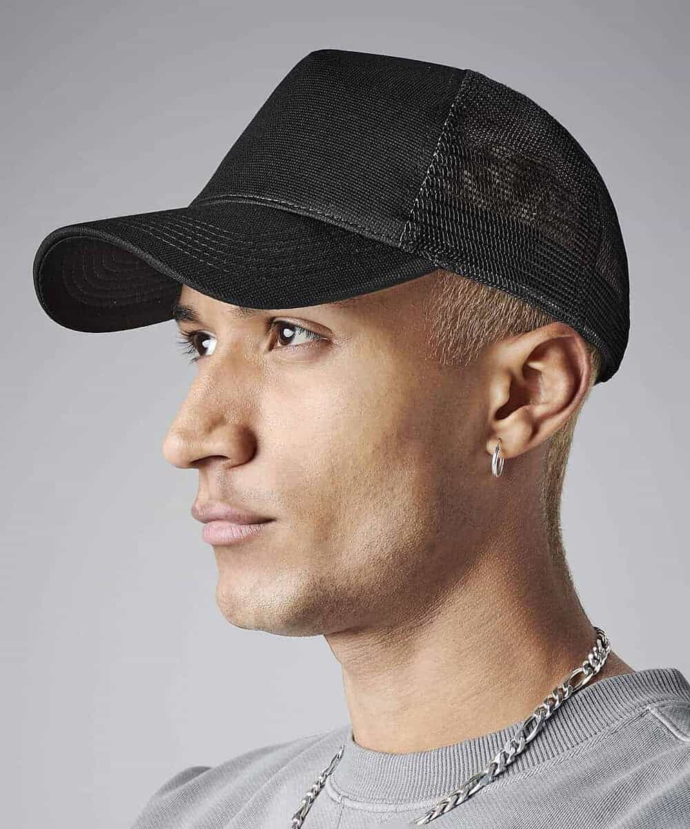 Black microknit snapback trucker cap with adjustable strap.