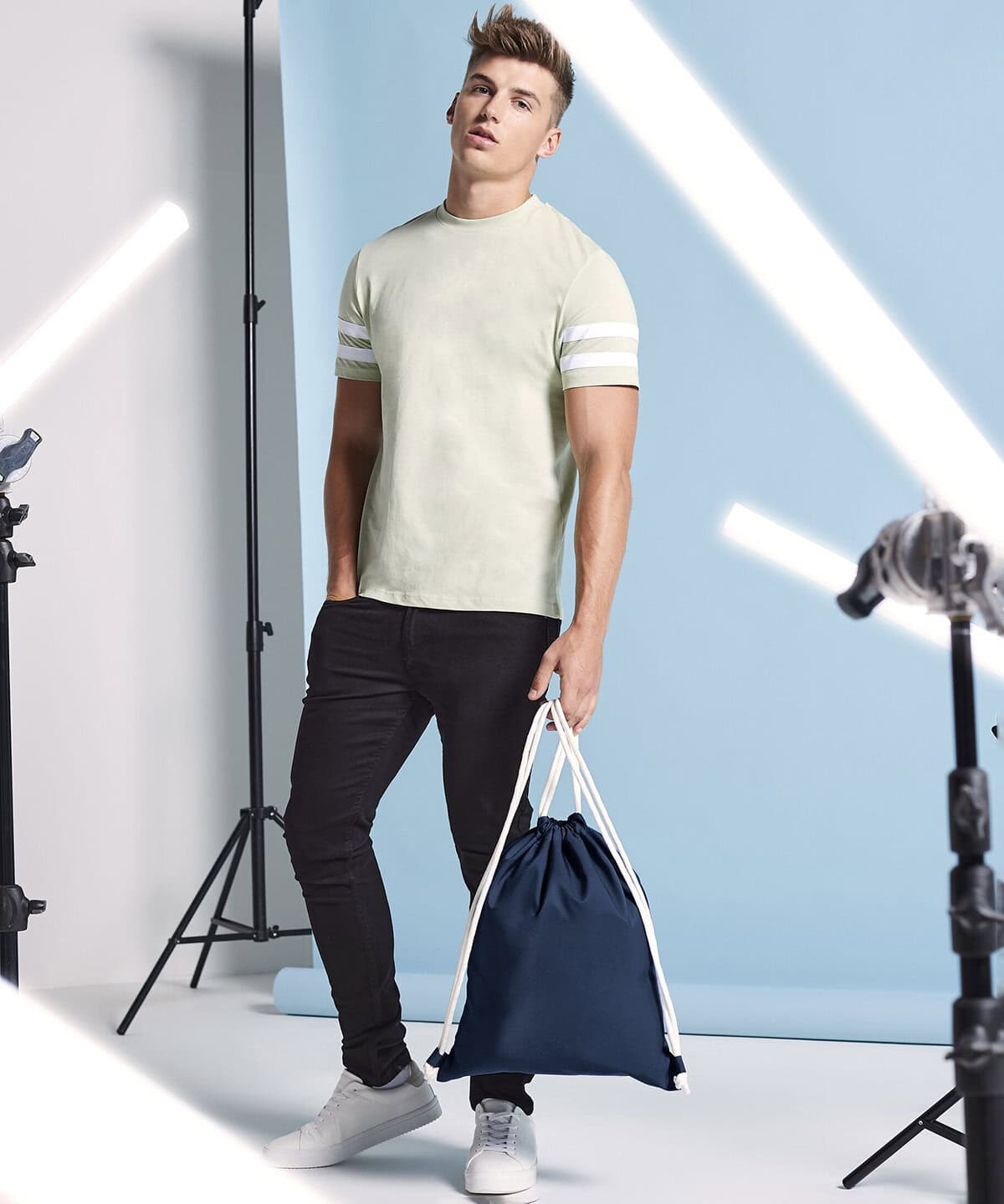 Bright young male model wearing personalised embroidered workwear and casual clothes for promotional photoshoot.