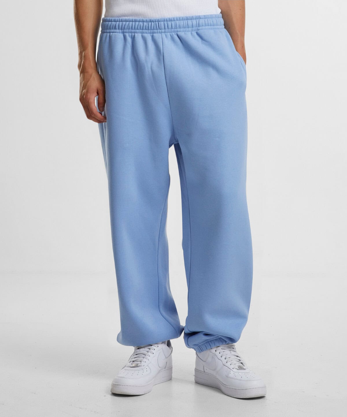 Comfortable light blue embroidered work trousers with elastic waist for casual or professional uniforms.
