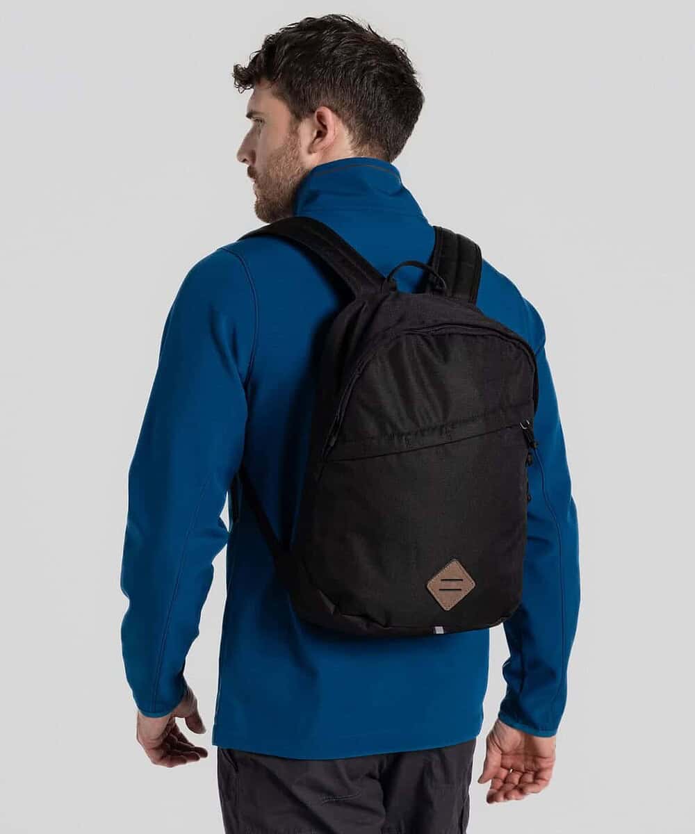 Back view of a man wearing a black Craghoppers Kiwi Backpack 14L.