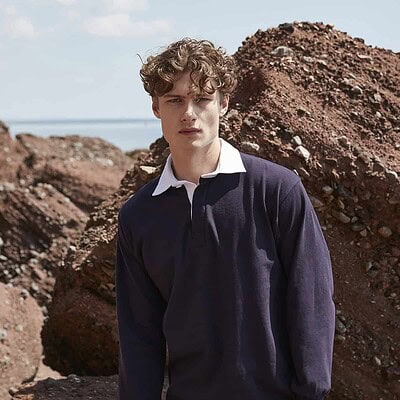 Man wearing a navy long sleeve rugby shirt outdoors, suitable for team sports.