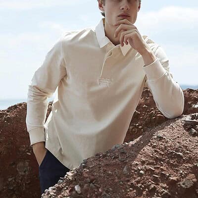 Man wearing a cream Front Row FR104 rugby shirt outdoors, showcasing professional workwear.