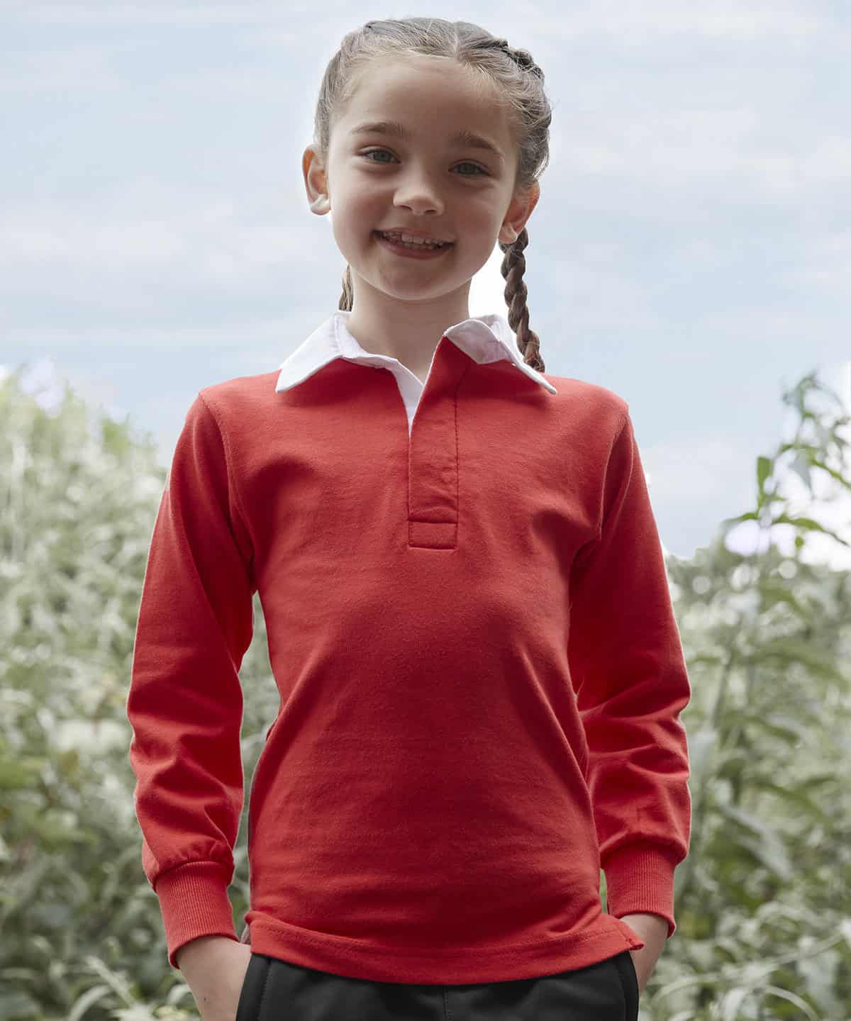 Bright red school uniform jumper with white collar, kid smiling outdoors.