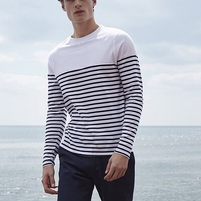 Man wearing a white and navy striped Breton long sleeve T-shirt by Dynamic Embroidery.