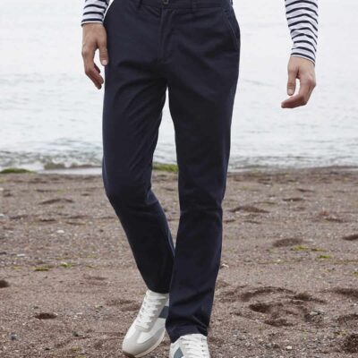 Close-up of men's navy work trousers suitable for professional uniforms on a beach setting.