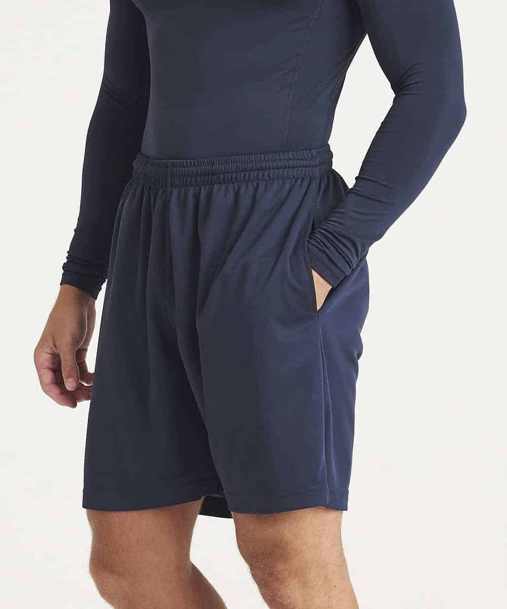 Man wearing navy blue athletic shorts and long-sleeve top, suitable for workwear.