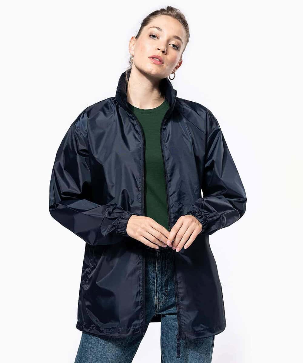 Woman wearing navy blue windbreaker jacket, suitable for everyday staff workwear.