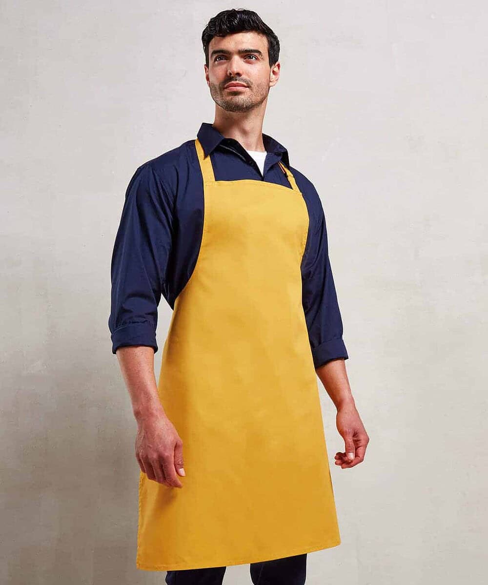 Bib apron in yellow for personalised embroidery and workwear. Durable and professional for catering,.