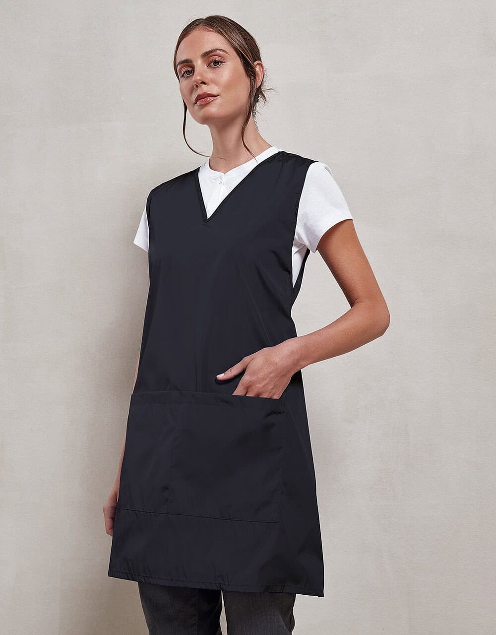 Bright black sleeveless work apron with large front pocket, perfect for embroidery, workwear, and uniforms. Durable material ideal for personalised embroidery in various industries.