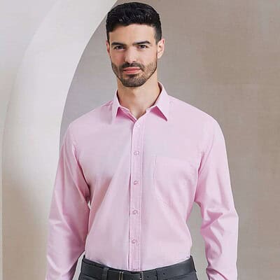 Man wearing a pink long sleeve poplin shirt for embroidery and printing.