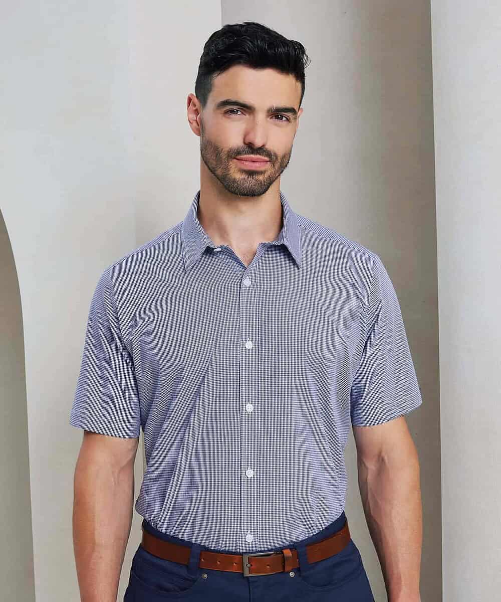 Man wearing a blue microcheck short sleeve cotton shirt for embroidery.