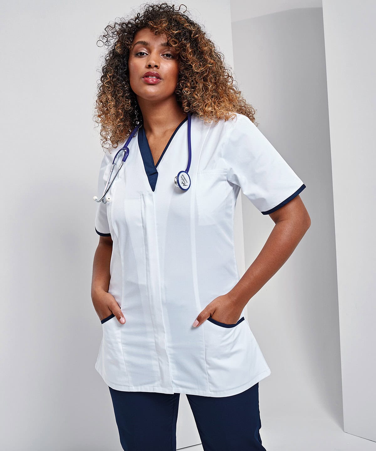 Comfortable white medical uniform with navy accents, perfect for healthcare professionals, featuring embroidered workwear and personalised uniforms.
