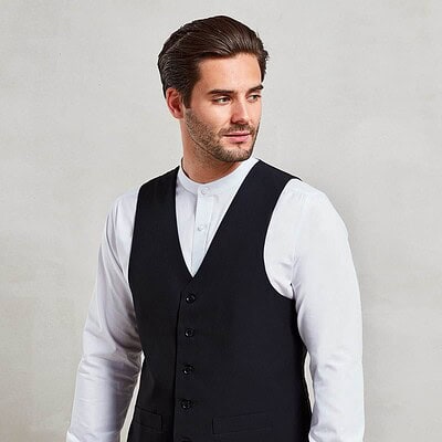 Man wearing a black lined polyester waistcoat for work or embroidery projects.