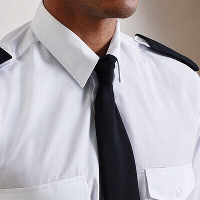 Embroidered police uniform with personalised clip tie for professional appearance.