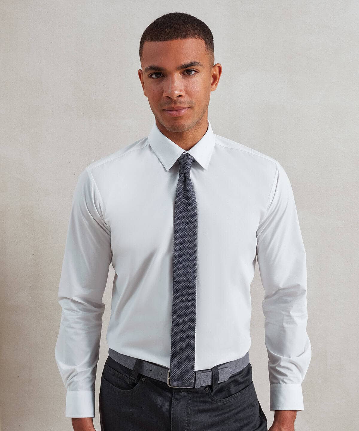 Elegant white shirt with slim tie, ideal for corporate or formal occasions.