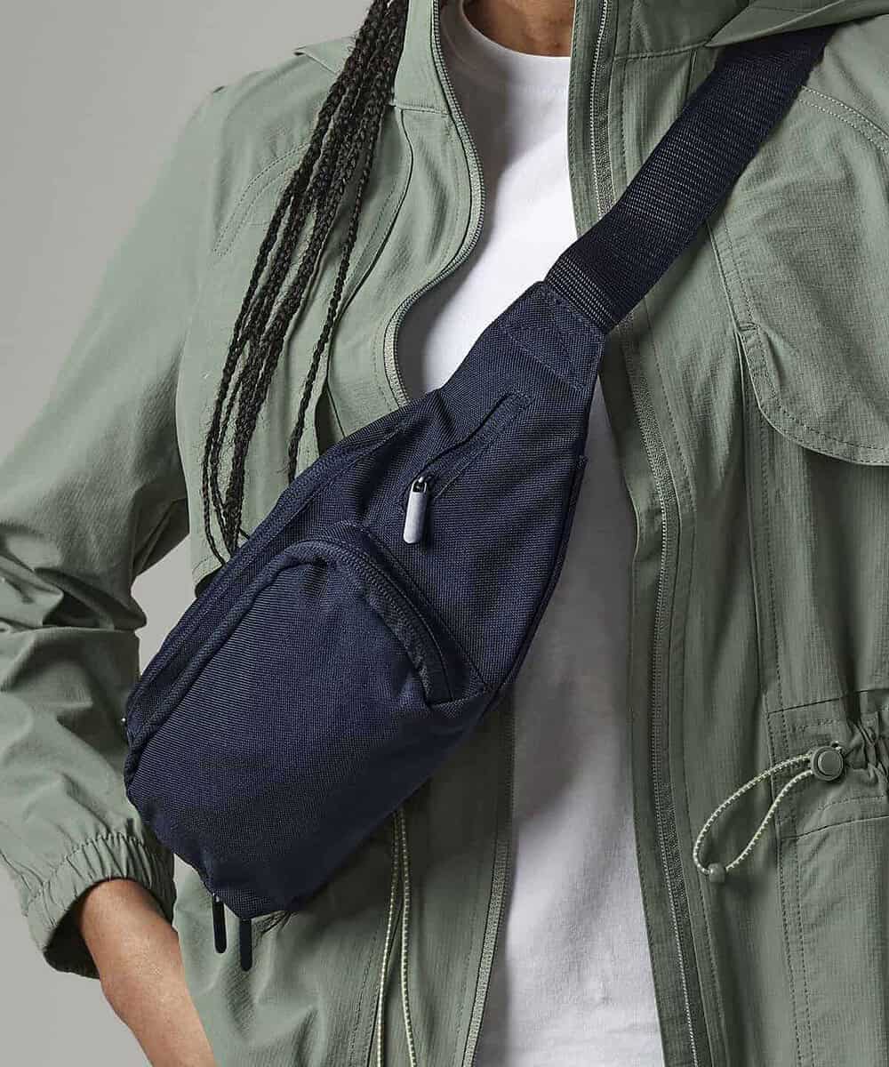 Navy belt bag worn across the chest, ideal for personalised embroidery projects.