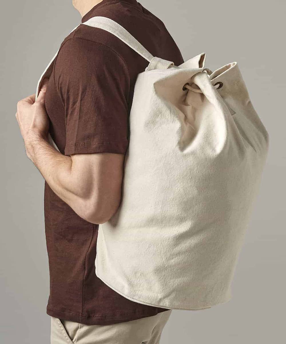 Embroidery canvas duffle bag held by a person, showcasing customisable workwear and printed clothing.