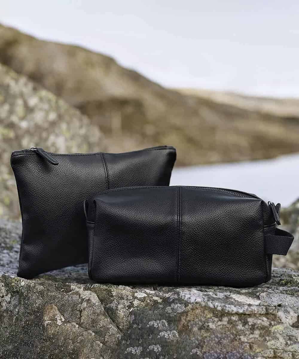 Embroidered black washbag displayed outdoors, ideal for personalised embroidery and promotional use.