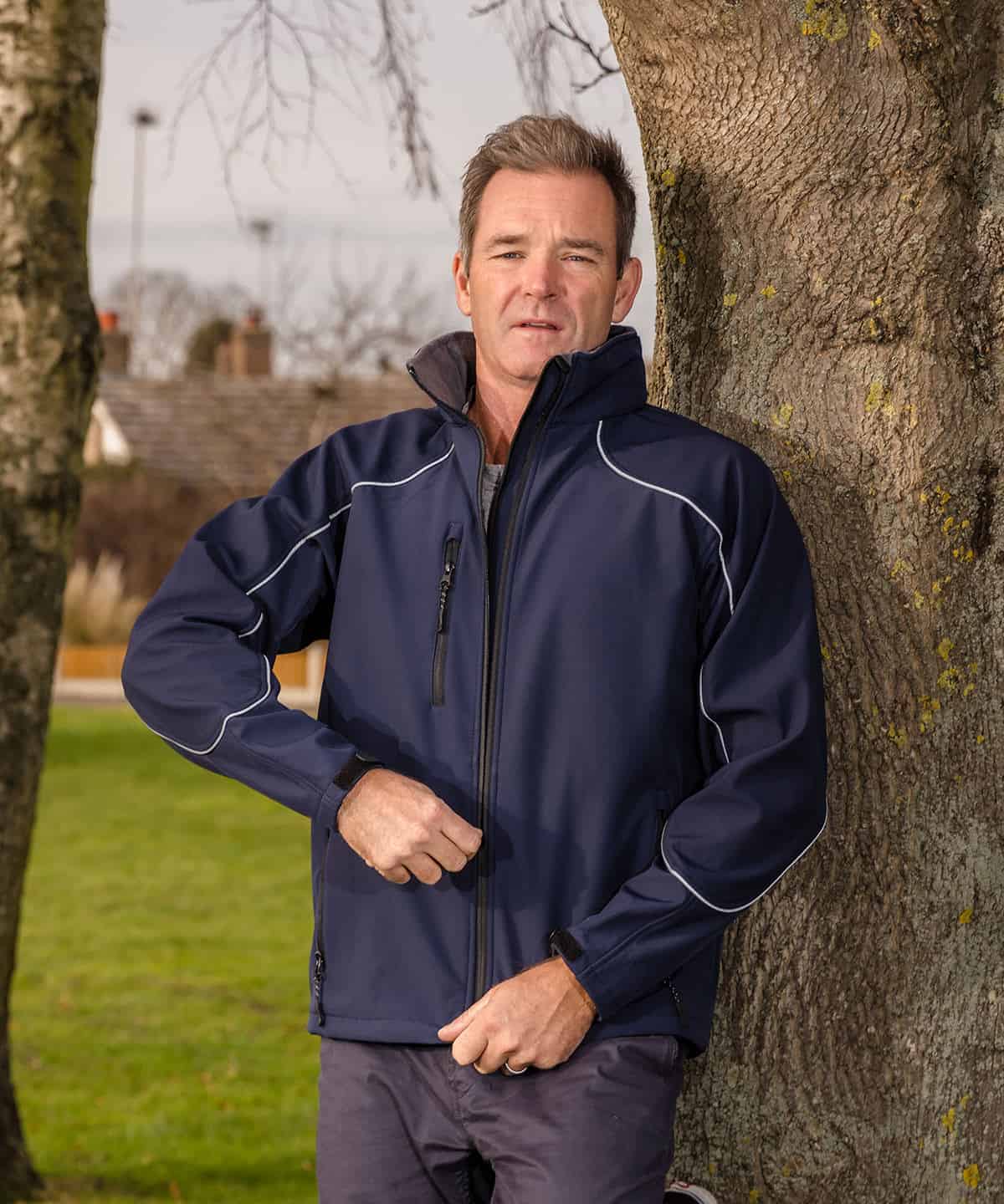 Men's navy waterproof softshell jacket, ideal for workwear and outdoor uniforms.