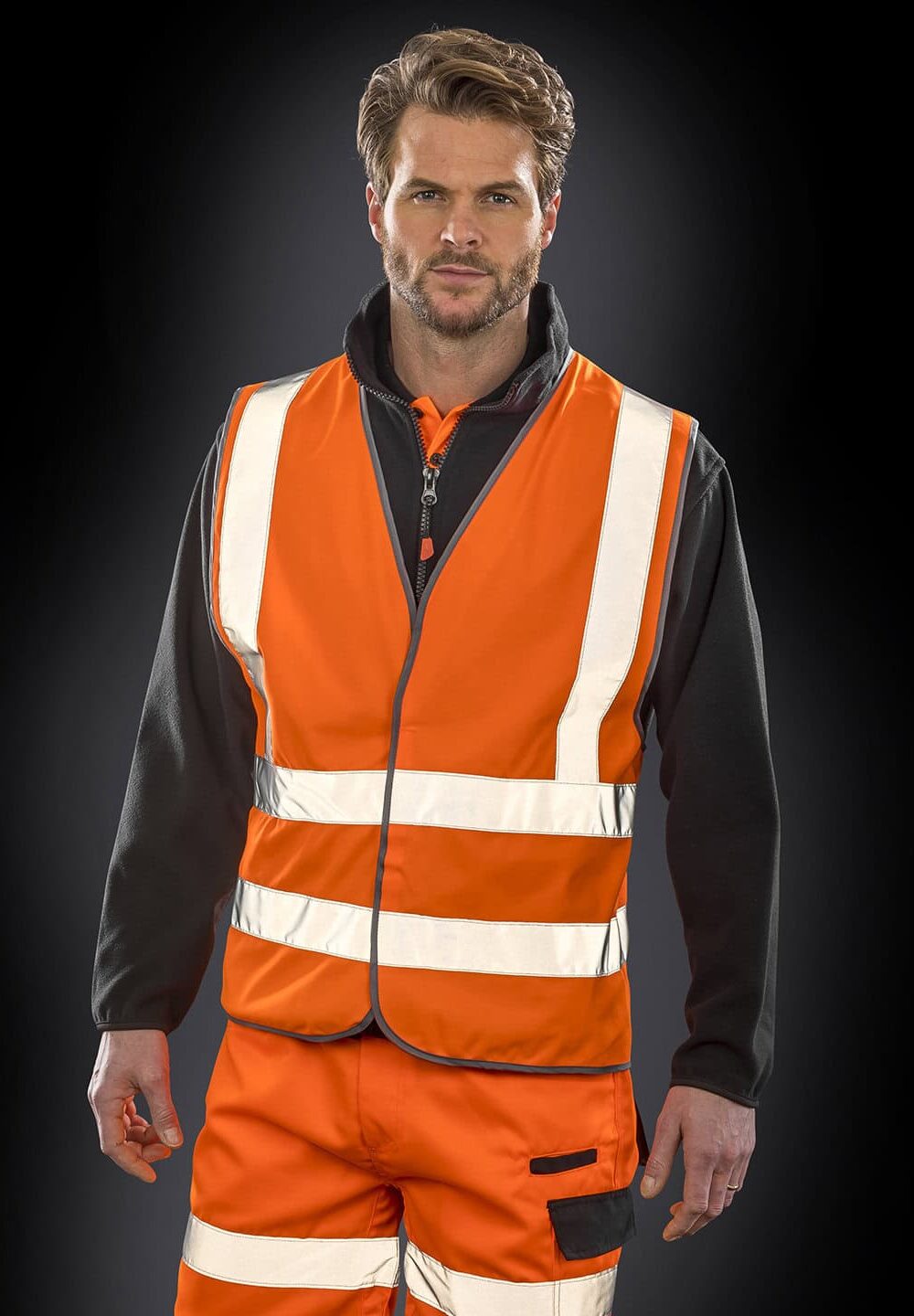 Reflective high visibility safety vest with black fleece hoodie for workwear.