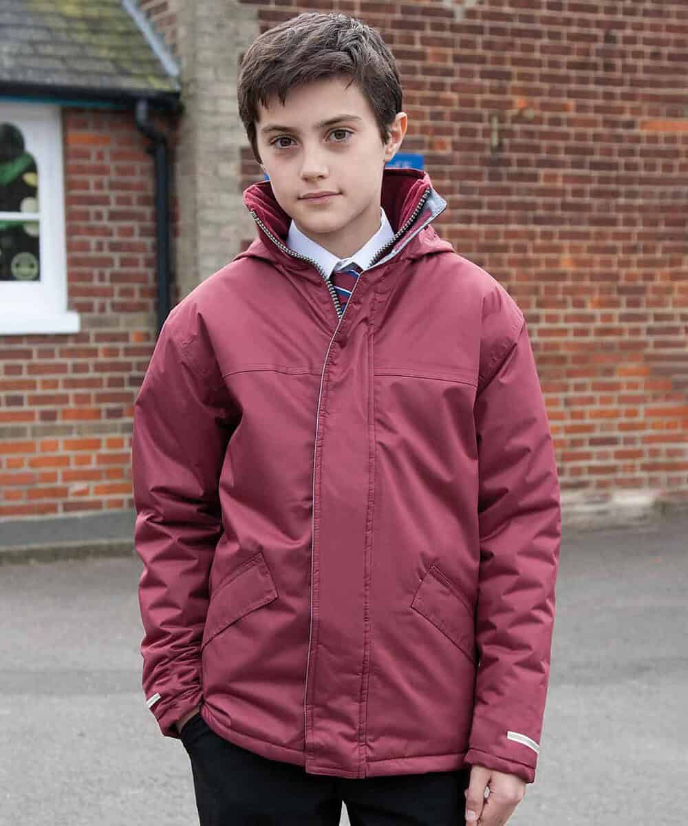 Child wearing a maroon winter parka outside, showcasing personalised embroidery options.