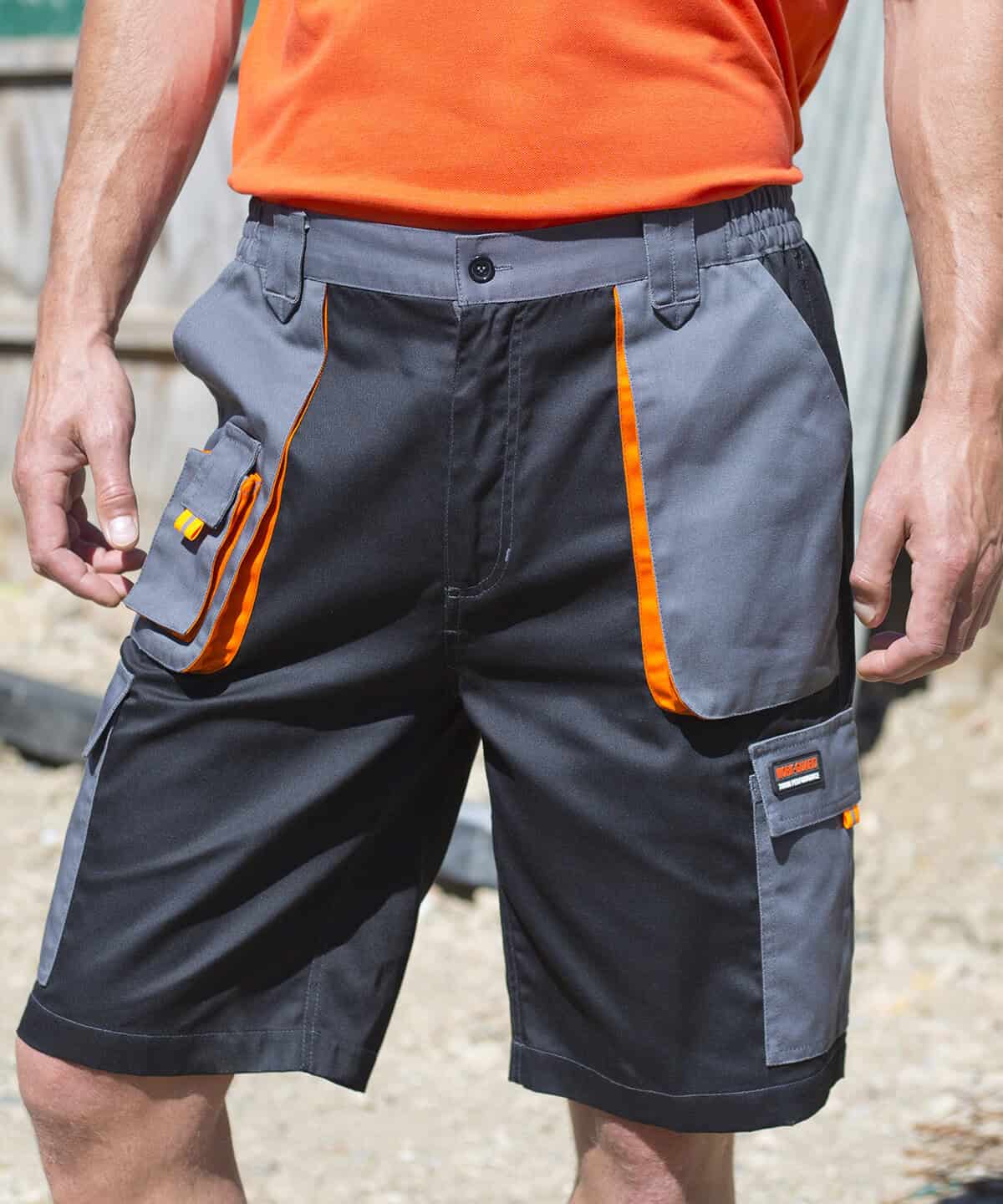 Durable workwear shorts with orange accents and multiple utility pockets for construction jobs.