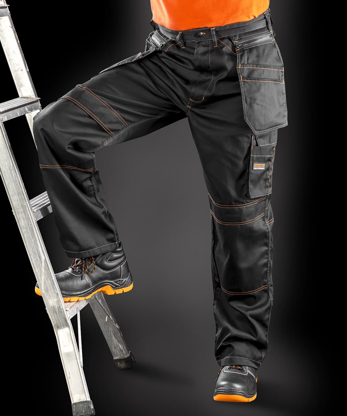 Durable black work trousers with orange stitching and multiple tool pockets for embroidery workwear.