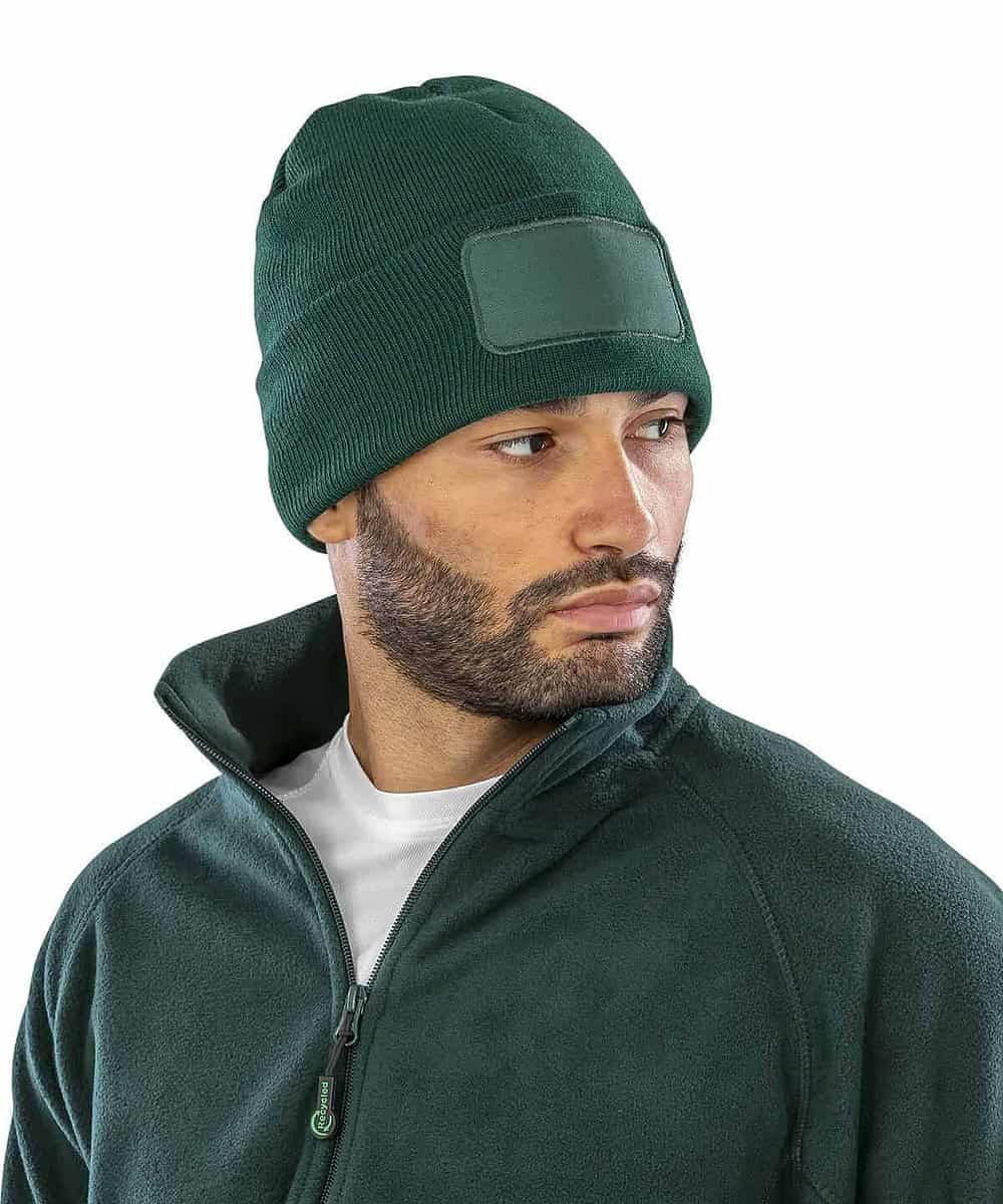 Embroidered green beanie hat with a blank patch, ideal for personalised branding or workwear.