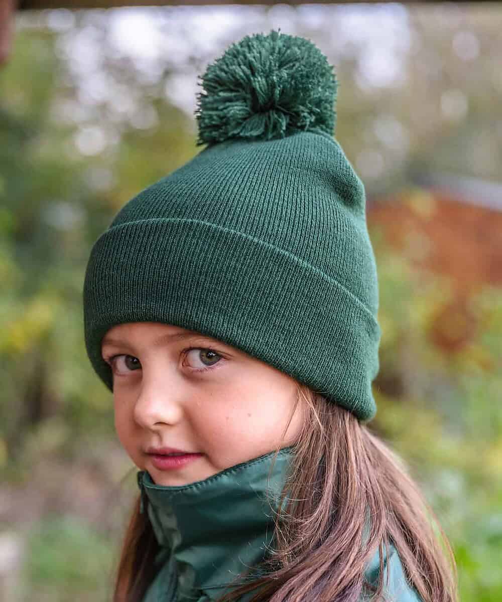 Embroidered winter beanie with pom pom, perfect for children, featuring space for custom logo embroi.