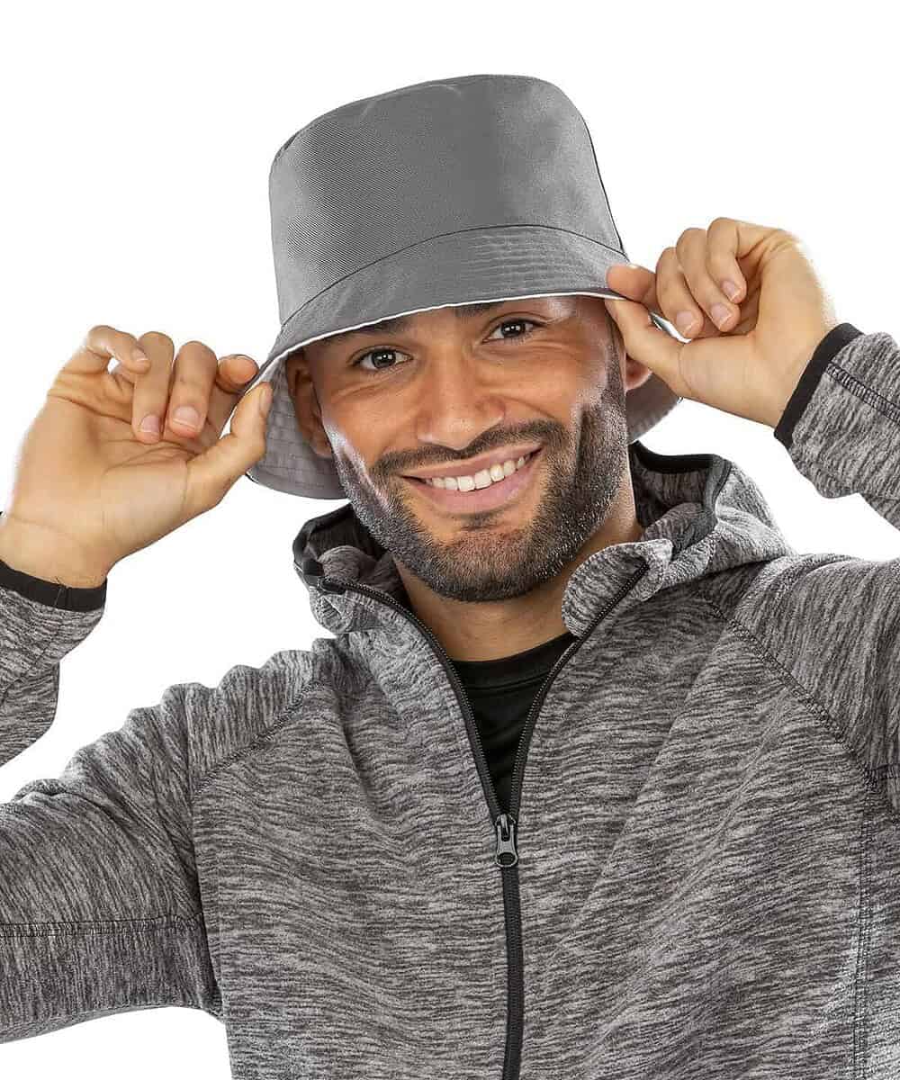 Man wearing a genuine recycled RC985 reversible bucket hat with logo.