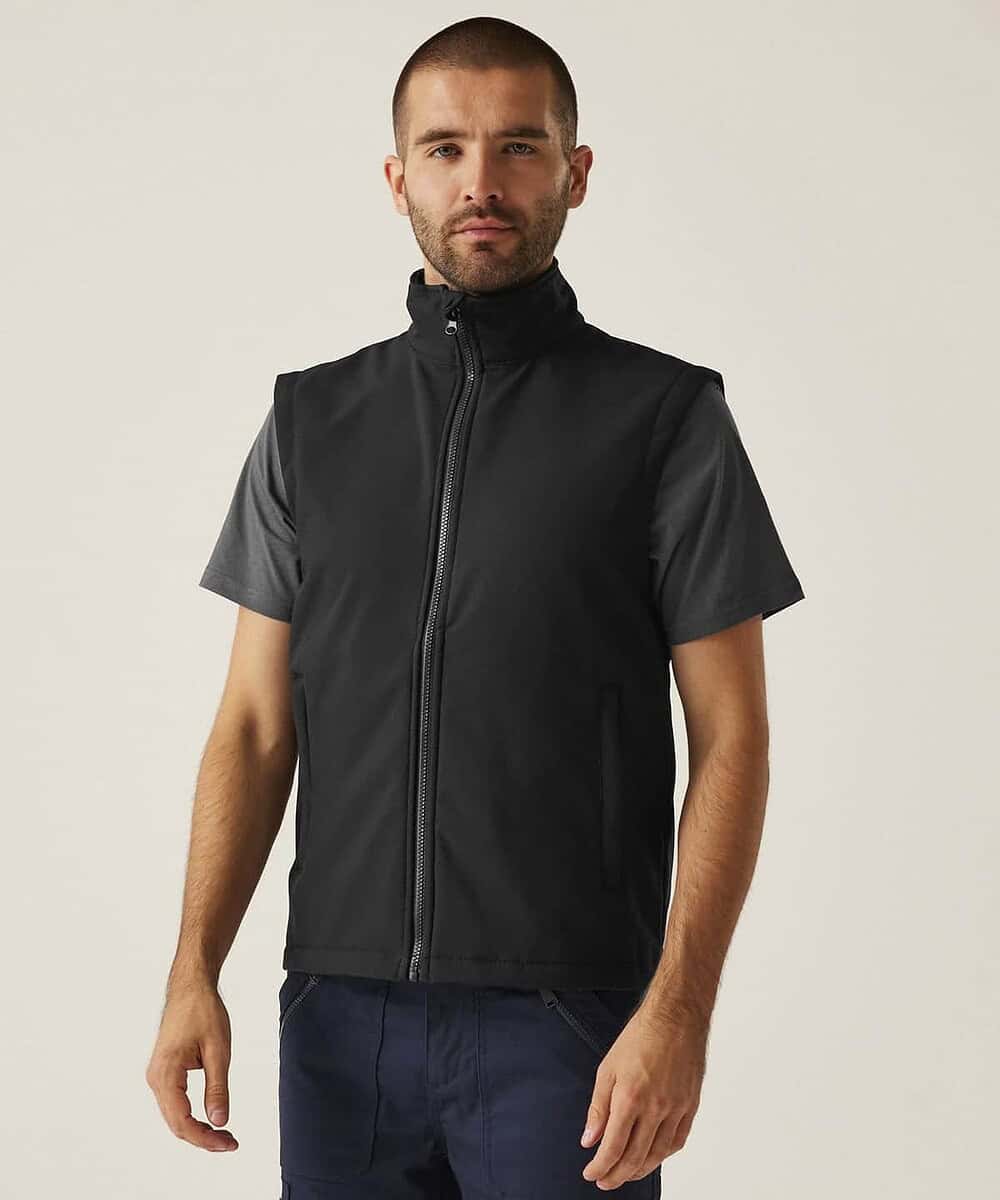 Man wearing black Regatta Ablaze printable softshell bodywarmer with logo.