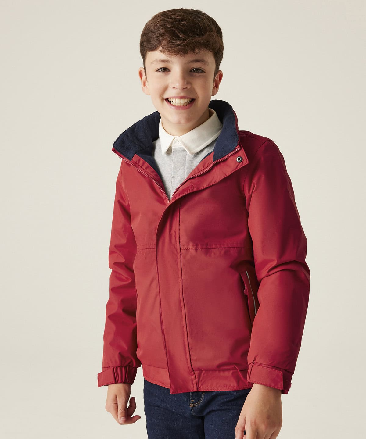 Bright red personalised workwear jacket for kids with embroidered logo, ideal for school uniform or promotional clothing.