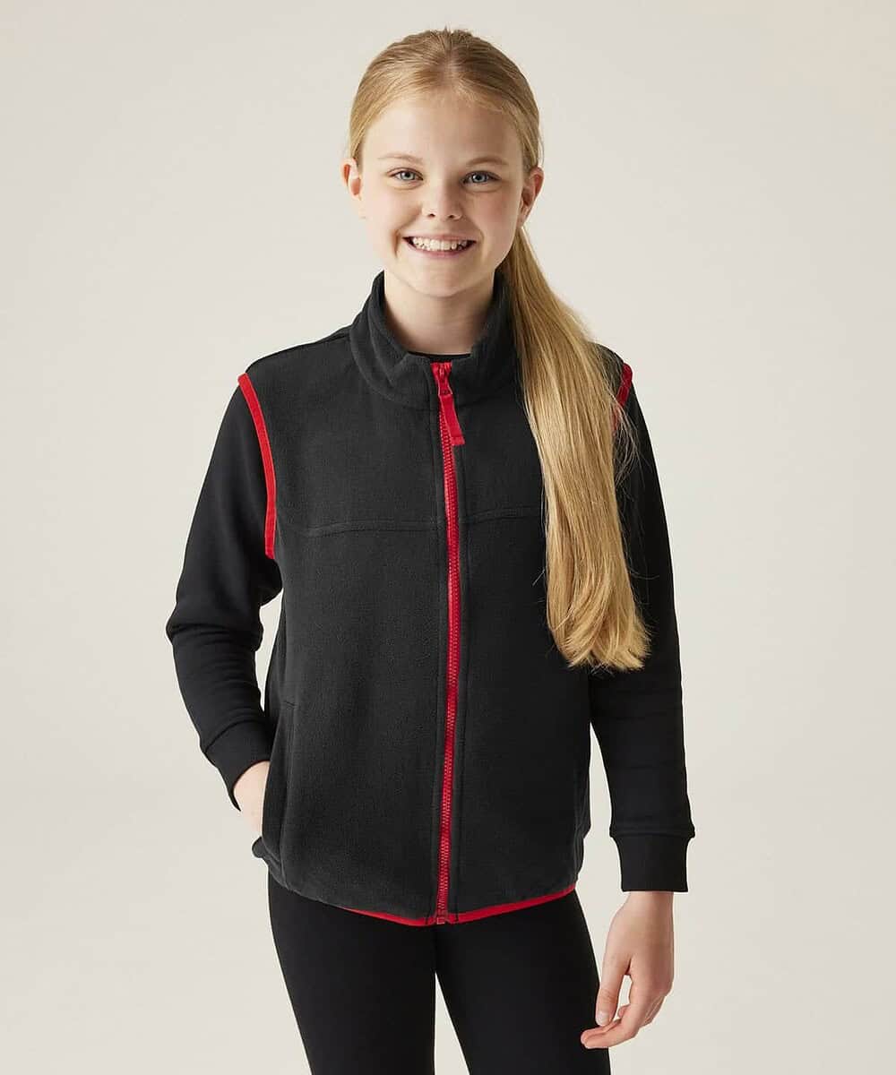 Girl wearing black and red Regatta junior microfleece bodywarmer for kids.